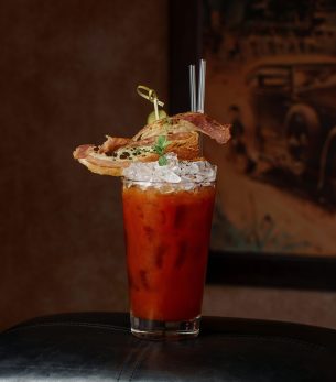 Alcoholic cocktail with ice and mint near the vintage wall. Alcoholic cocktail with ice and mint near the vintage wall.