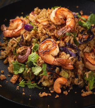 Grilled shrimp salad Grilled shrimp salad on a black plate and black background